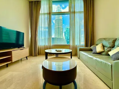 a living room with a couch and a large window at vortex suites apatment by sapporo in Kuala Lumpur