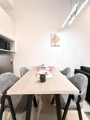 a dining room with a wooden table and chairs at Chambers Suites By Grands in Kuala Lumpur