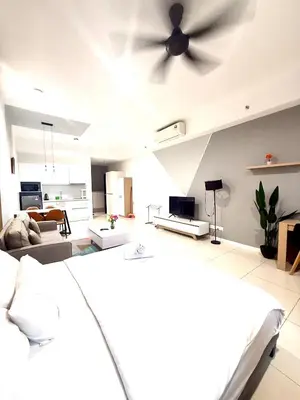 a bedroom with a ceiling fan and a living room at Chambers Suites By Grands in Kuala Lumpur