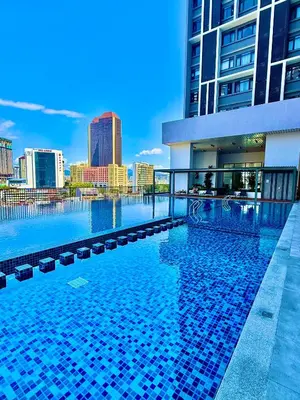a swimming pool with a city skyline in the background at Chambers Suites By Grands in Kuala Lumpur