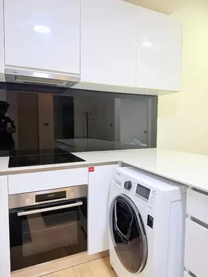 a white kitchen with a washing machine in it at Star Residence klcc by Aqua in Kuala Lumpur