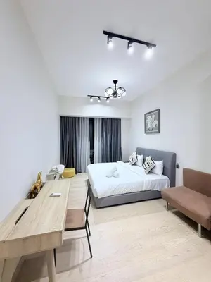 a bedroom with a bed and a desk in it at Star Residence klcc by Aqua in Kuala Lumpur