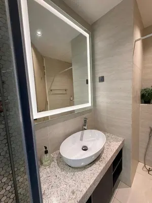 a bathroom with a white sink and a mirror at Star Residence klcc by Aqua in Kuala Lumpur
