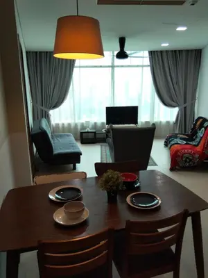 a living room with a wooden table and chairs at Vortex suites Klcc near KL in Kuala Lumpur