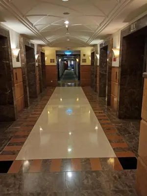 a hallway in a building with a tile floor at Times square Suites at Time Square KL in Kuala Lumpur