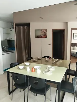 a dining room with a white table and chairs at Vortex suites Klcc near KL Area in Kuala Lumpur