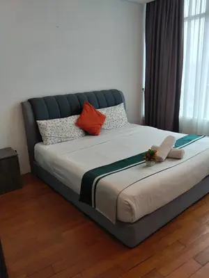 a large bed in a bedroom with flowers on it at Vortex suites Klcc near KL Area in Kuala Lumpur