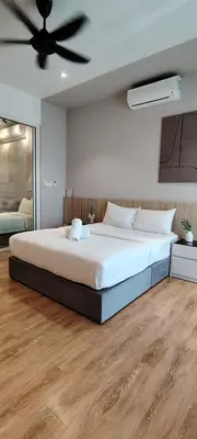 a bedroom with a large bed with a ceiling fan at Sky Suites at Quill Residence Kuala Lumpur in Kuala Lumpur