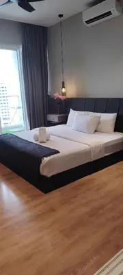 a large bed in a bedroom with a large window at Sky Suites at Quill Residence Kuala Lumpur in Kuala Lumpur