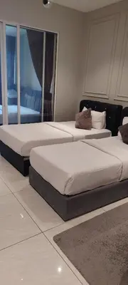two beds sitting in a room with at Sky Suites at Quill Residence Kuala Lumpur in Kuala Lumpur