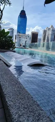 a pool of water with a city in the background at Sky Suites at Quill Residence Kuala Lumpur in Kuala Lumpur