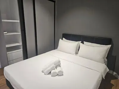 a white bed with two towels on top of it at Spacious Stylish Suite at Quill Resi KLCC 2Bed7Pax in Kuala Lumpur