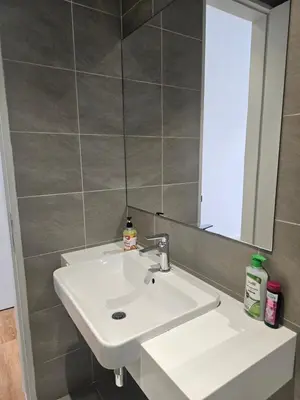 a bathroom with a white sink and a mirror at Spacious Stylish Suite at Quill Resi KLCC 2Bed7Pax in Kuala Lumpur