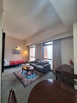 a living room with a couch and a table at Suite at Bukit Bintang in Kuala Lumpur