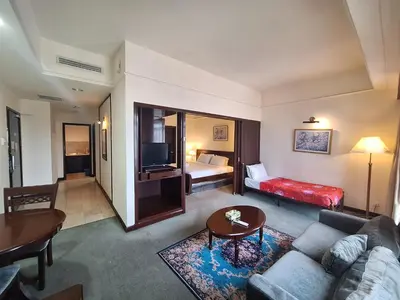 a living room with a couch and a bed at Suite at Bukit Bintang in Kuala Lumpur