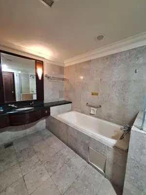 a large bathroom with a tub and a mirror at Suite at Bukit Bintang in Kuala Lumpur