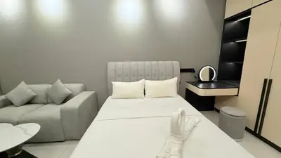 a small room with a bed and a couch at Majestic Sky Deck Suites in Kuala Lumpur
