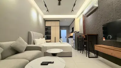 a living room with a couch and a tv at Majestic Sky Deck Suites in Kuala Lumpur