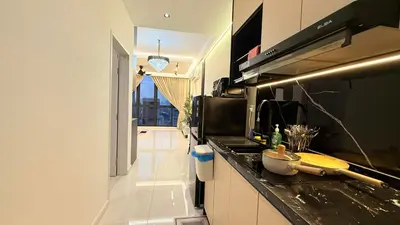 a kitchen with a counter top and a stove top oven at Majestic Sky Deck Suites in Kuala Lumpur
