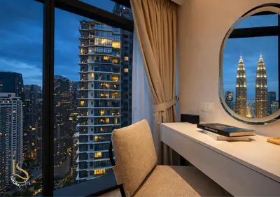 a room with a desk and a view of a city at LUXURA SUITE's E A T O N KLCC in Kuala Lumpur