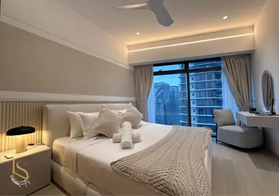 a bedroom with a large white bed with a window at LUXURA SUITE's E A T O N KLCC in Kuala Lumpur