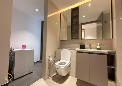 a bathroom with a toilet and a sink at LUXURA SUITE's E A T O N KLCC in Kuala Lumpur