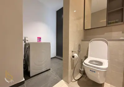 a bathroom with a white toilet in a stall at LUXURA SUITE's E A T O N KLCC in Kuala Lumpur