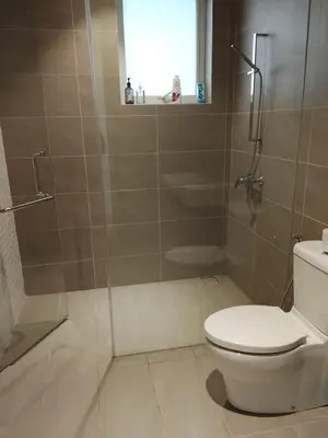a bathroom with a shower and a toilet at Quill Luxury Suites KLCC in Kuala Lumpur