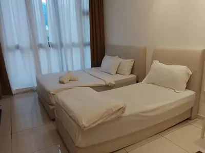 two beds sitting next to each other in a room at Quill Luxury Suites KLCC in Kuala Lumpur