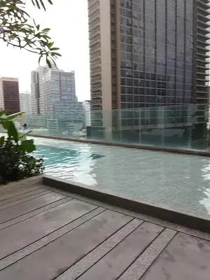 a swimming pool in a city with tall buildings at Quill Luxury Suites KLCC in Kuala Lumpur