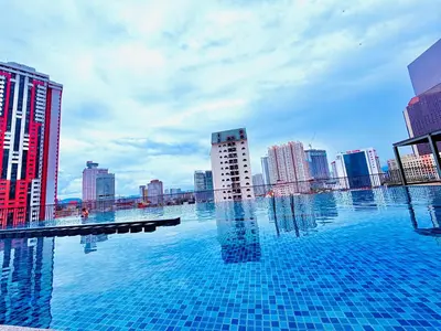 a large swimming pool in a city with tall buildings at Chambers Suites KLCC in Kuala Lumpur