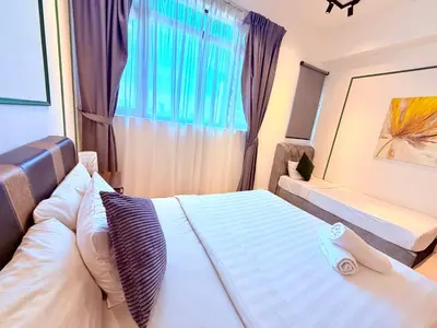 a bedroom with a bed and a window at Chambers Suites KLCC in Kuala Lumpur