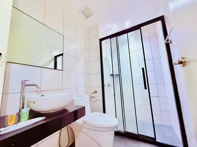 a white bathroom with a sink and a toilet at Chambers Suites KLCC in Kuala Lumpur