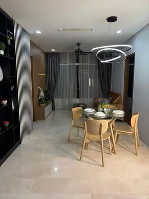 a dining room and living room with a table and chairs at SKY SUITES DMK KHADIZA GLOBAL BY KLcc in Kuala Lumpur