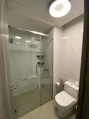 a bathroom with a toilet and a glass shower at Agile Heaven Luxury Suite bukit bintang in Kuala Lumpur