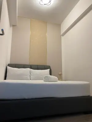 a bedroom with a large bed with white pillows at Agile Heaven Luxury Suite bukit bintang in Kuala Lumpur