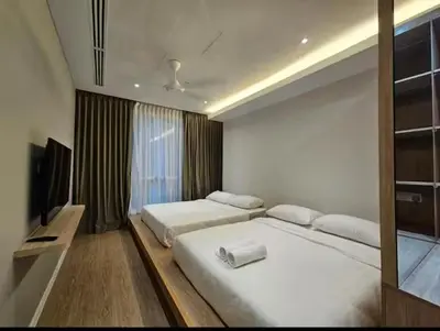 a bedroom with two beds and a flat screen tv at New Soho Binjai 8 KLCC in Kuala Lumpur