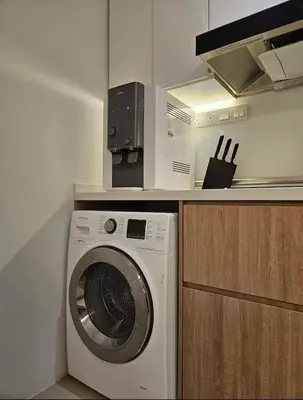a kitchen with a washing machine and a microwave at New Soho Binjai 8 KLCC in Kuala Lumpur