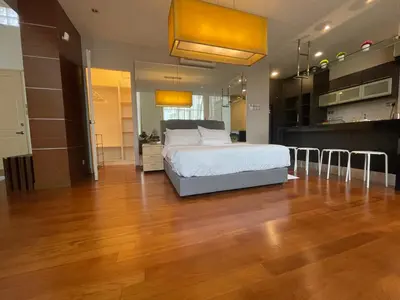 a large bedroom with a bed and a wooden floor at Kuala Lumpur luxury Duplex suits in Kuala Lumpur