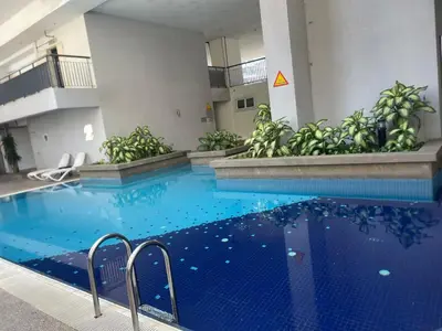 a large swimming pool with blue water in a building at Kuala Lumpur luxury Duplex suits in Kuala Lumpur