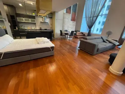 a large living room with a bed and a couch at Kuala Lumpur luxury Duplex suits in Kuala Lumpur