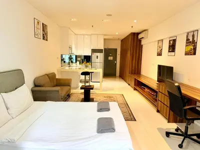 a bedroom with a bed and a living room at Chod ling pong by mercu summer KLCC in Kuala Lumpur