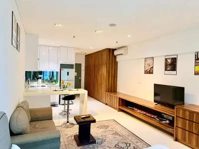 a living room with a couch and a kitchen at Chod ling pong by mercu summer KLCC in Kuala Lumpur