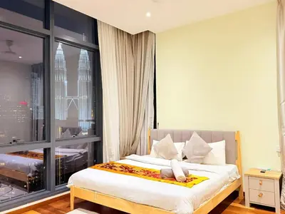 a bedroom with a bed with a large window at Next To KLCC By Home Stay in Kuala Lumpur