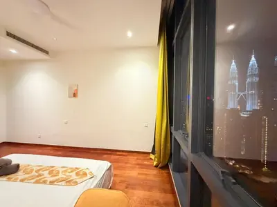 a room with a bed and a window with a city at Next To KLCC By Home Stay in Kuala Lumpur