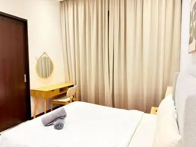 a bedroom with a bed and a desk and a mirror at Home Town Next To Kuala Lumpur City in Kuala Lumpur