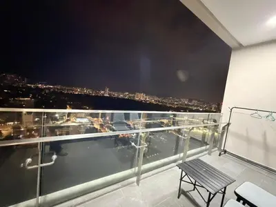 a balcony with a view of a city at night at Home Town Next To Kuala Lumpur City in Kuala Lumpur