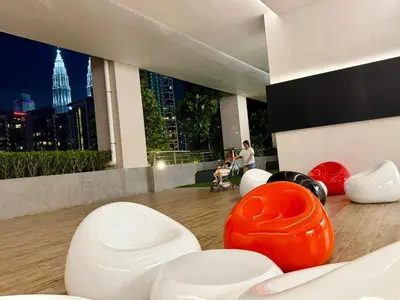 a living room with white chairs and a large window at Home Town Next To Kuala Lumpur City in Kuala Lumpur
