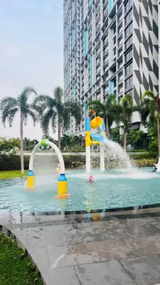 a water park with a fountain in a city at The Grand Suites - Trion KL in Kuala Lumpur