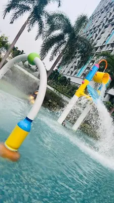 a pool with two inflatableadders in the water at The Grand Suites - Trion KL in Kuala Lumpur